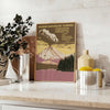 Illustration of a national park with mountains and trees in muted colors - styled on a counter with eucalyptus and a bowl of lemons