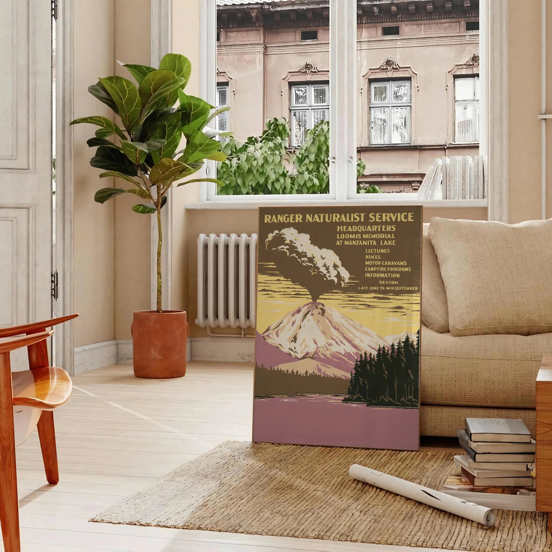 Illustration of a national park with mountains and trees in muted colors - in a Parisian living room with a sofa and a fig plant