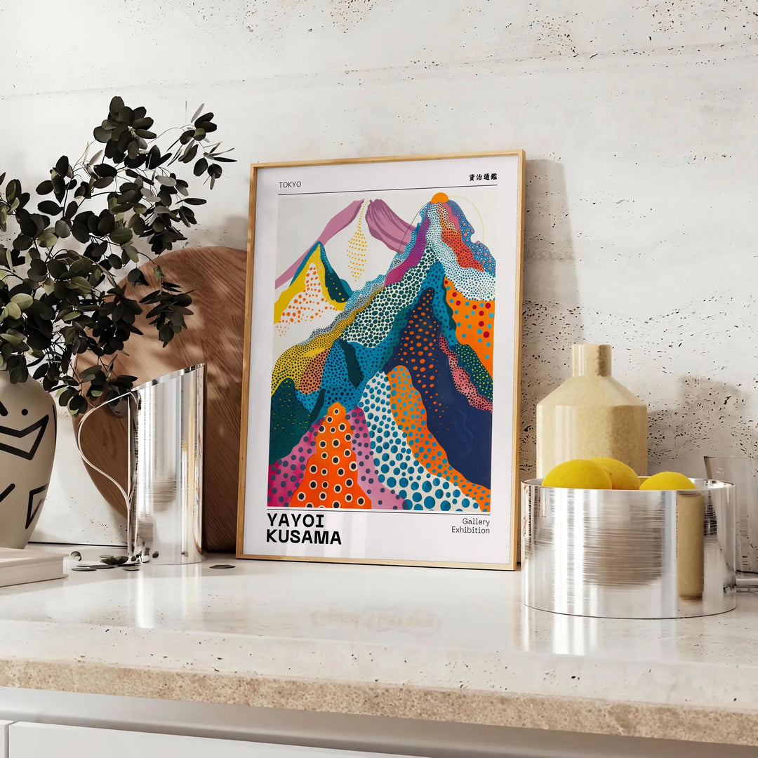 Colorful abstract nature scene by Yayoi Kusama featuring blue and orange patterns - styled on a counter with eucalyptus and a bowl of lemons