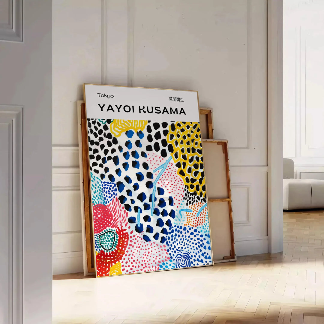 Colorful abstract nature scene by Yayoi Kusama with polka dots - leaning on a herringbone floor against a white panelled wall
