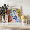 Colorful abstract nature scene by Yayoi Kusama with polka dots - styled on a counter with eucalyptus and a bowl of lemons