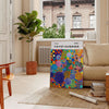 Abstract nature scene in Yayoi Kusama's iconic polka dot style with blue and earthy tones - in a Parisian living room with a sofa and a fig plant