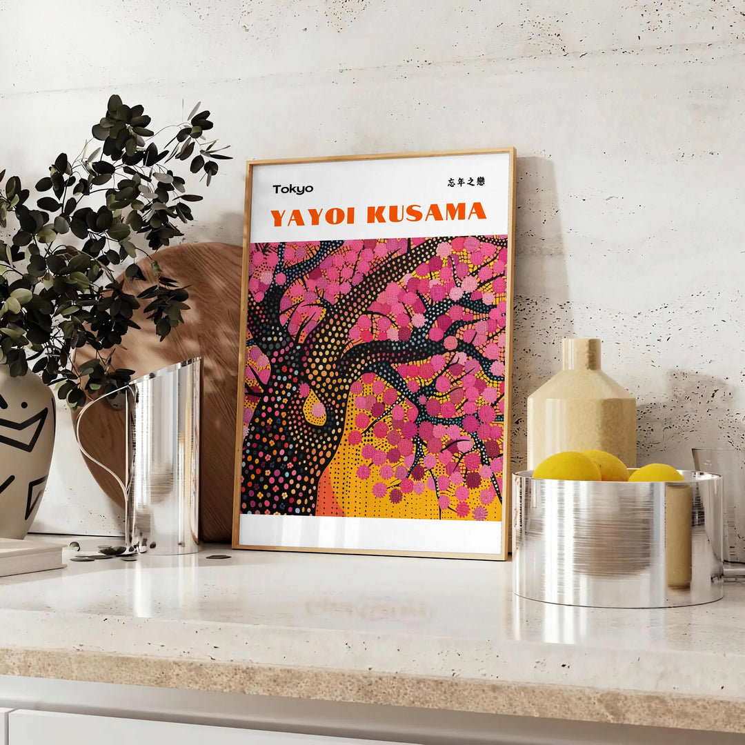 Abstract nature scene with polka dots in black and brown by Yayoi Kusama - styled on a counter with eucalyptus and a bowl of lemons