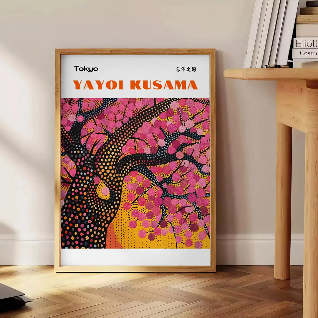Abstract nature scene with polka dots in black and brown by Yayoi Kusama - beside a round wooden side table with books
