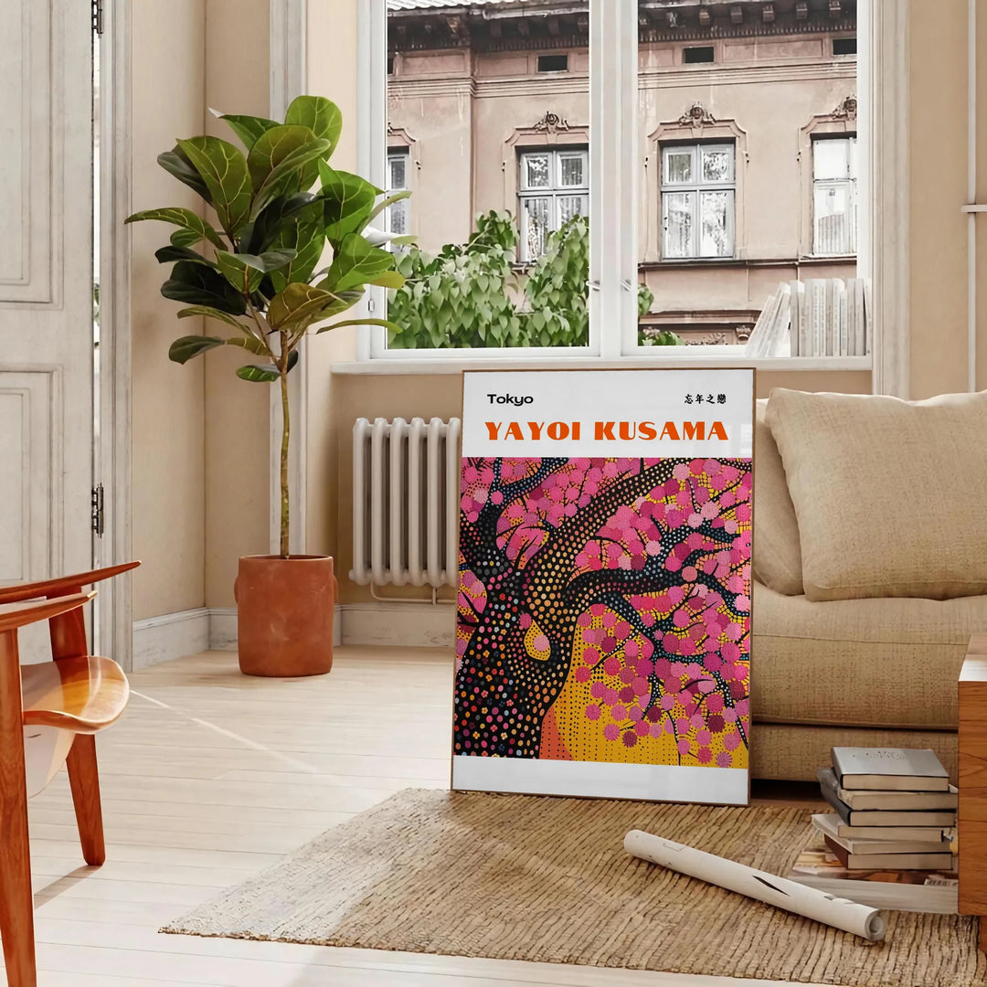 Abstract nature scene with polka dots in black and brown by Yayoi Kusama - in a Parisian living room with a sofa and a fig plant