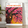 Abstract nature scene with polka dots in black and brown by Yayoi Kusama - in a bright minimalist room with a plant and an armchair