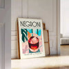 Illustration of a Negroni cocktail with orange and blue accents - leaning on a herringbone floor against a white panelled wall