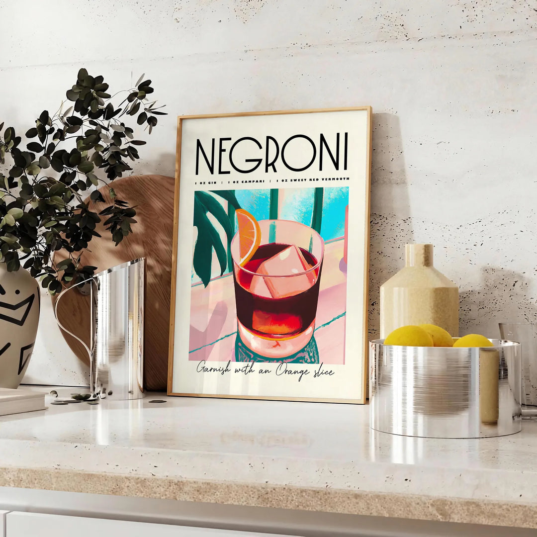 Illustration of a Negroni cocktail with orange and blue accents - styled on a counter with eucalyptus and a bowl of lemons