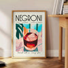 Illustration of a Negroni cocktail with orange and blue accents - beside a round wooden side table with books