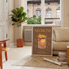 Illustration of a Negroni cocktail with orange and green hues - in a Parisian living room with a sofa and a fig plant