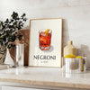 Illustration of a Negroni cocktail in a sleek glass, with orange and black colors - styled on a counter with eucalyptus and a bowl of lemons