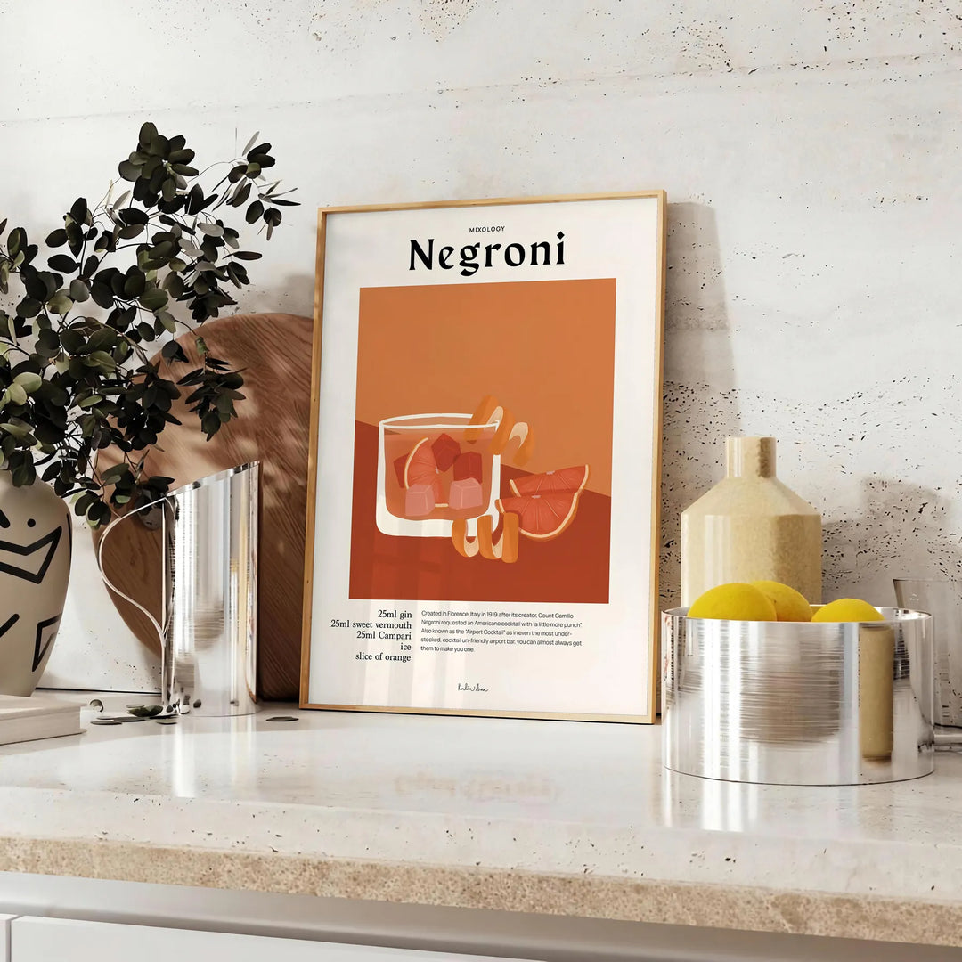 Illustration of a Negroni cocktail in orange and black tones - styled on a counter with eucalyptus and a bowl of lemons