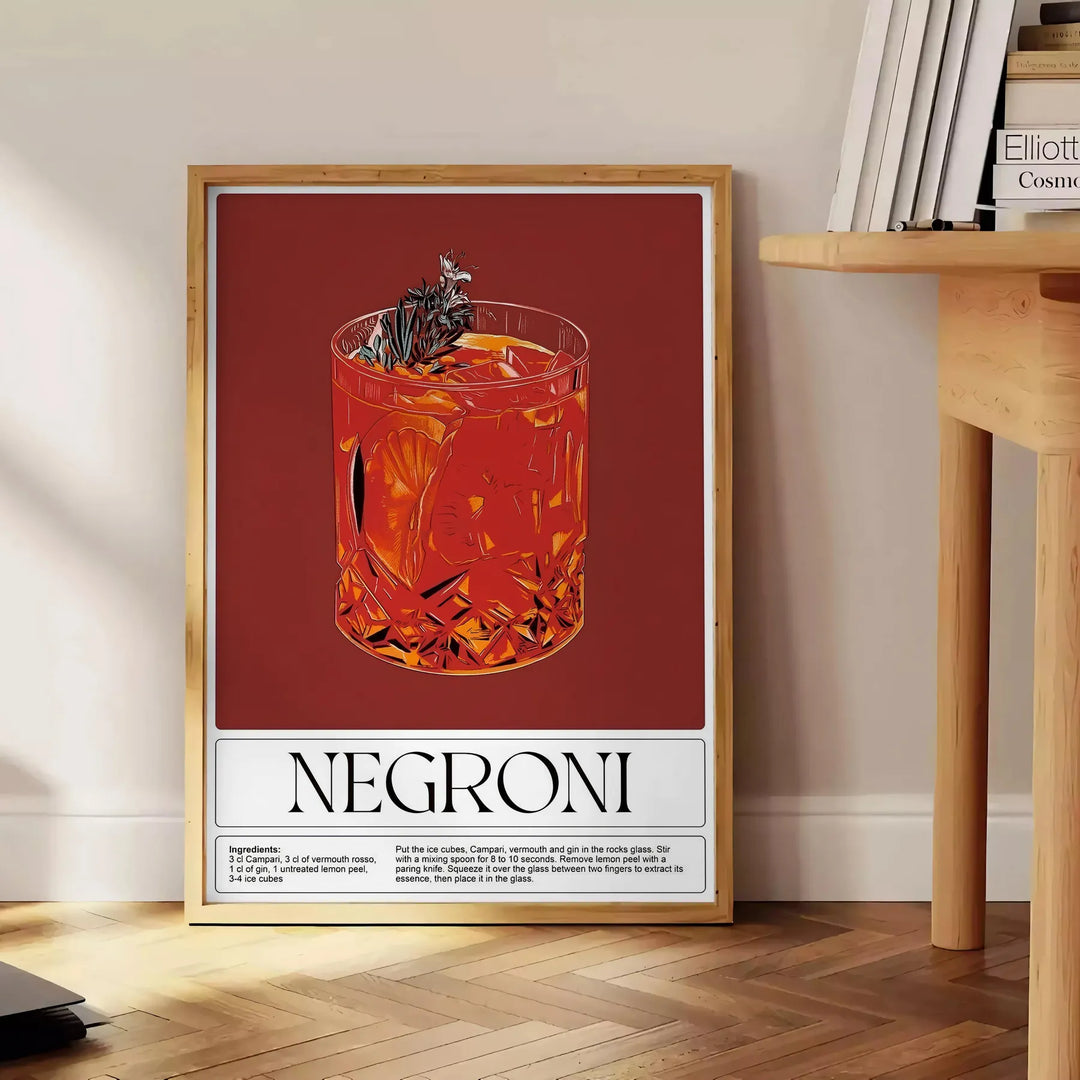 A colorful illustration of a Negroni cocktail in a glass with orange garnish - beside a round wooden side table with books