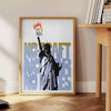 A travel poster featuring New York's skyline in black and orange hues - beside a round wooden side table with books