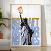 A travel poster featuring New York's skyline in black and orange hues - in a bright minimalist room with a plant and an armchair
