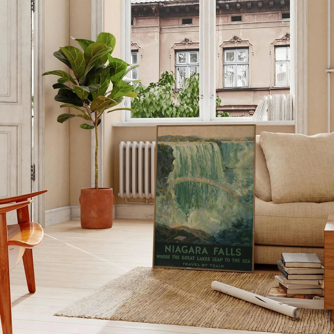 A vintage travel poster featuring Niagara Falls with green and gray tones - in a Parisian living room with a sofa and a fig plant