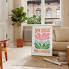 Colorful flowers in a groovy style with brown and green tones - in a Parisian living room with a sofa and a fig plant