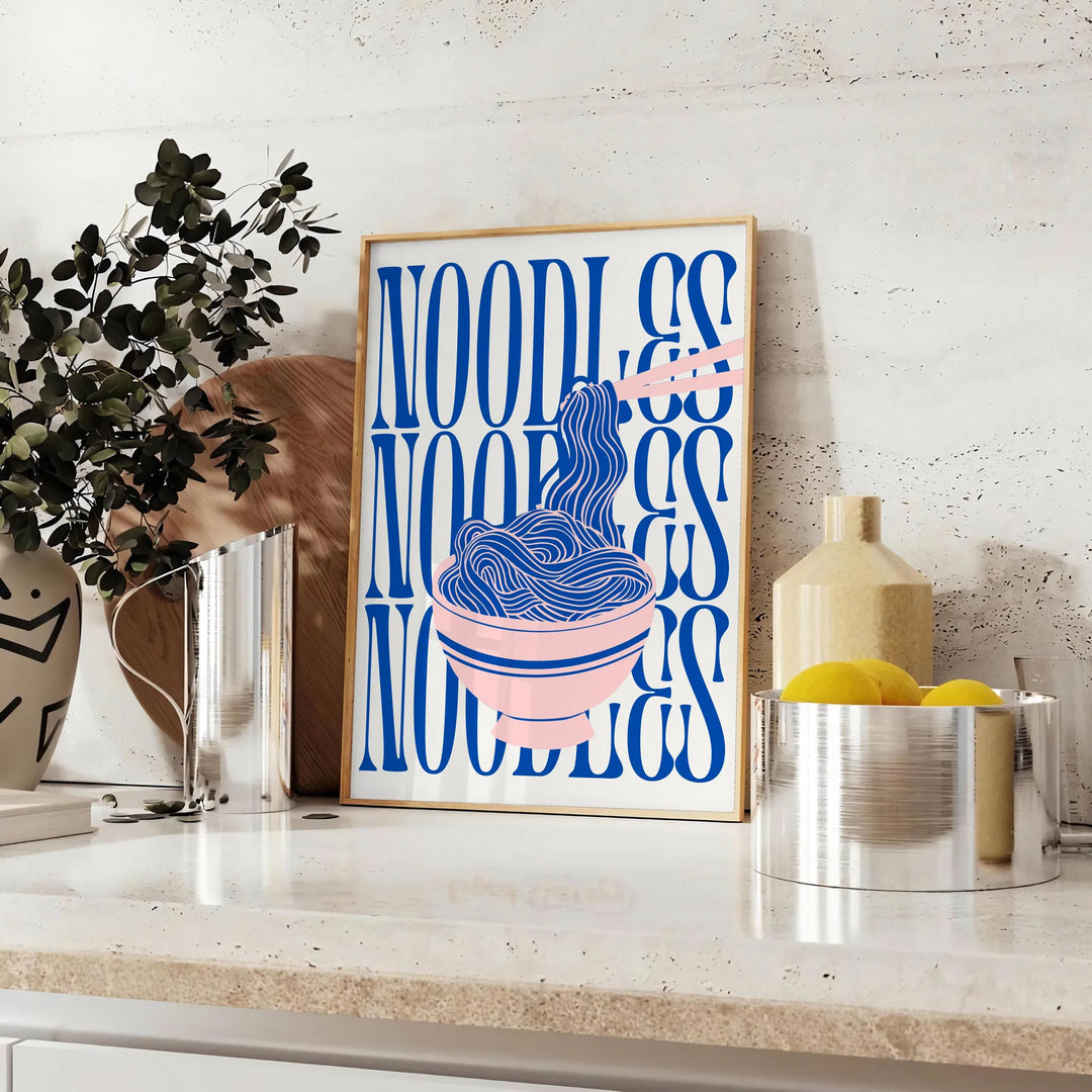 A minimalist poster featuring a bowl of noodles in gray and green tones - styled on a counter with eucalyptus and a bowl of lemons