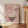 A minimalist kitchen scene featuring a bowl of noodles on a gray background - beside a round wooden side table with books