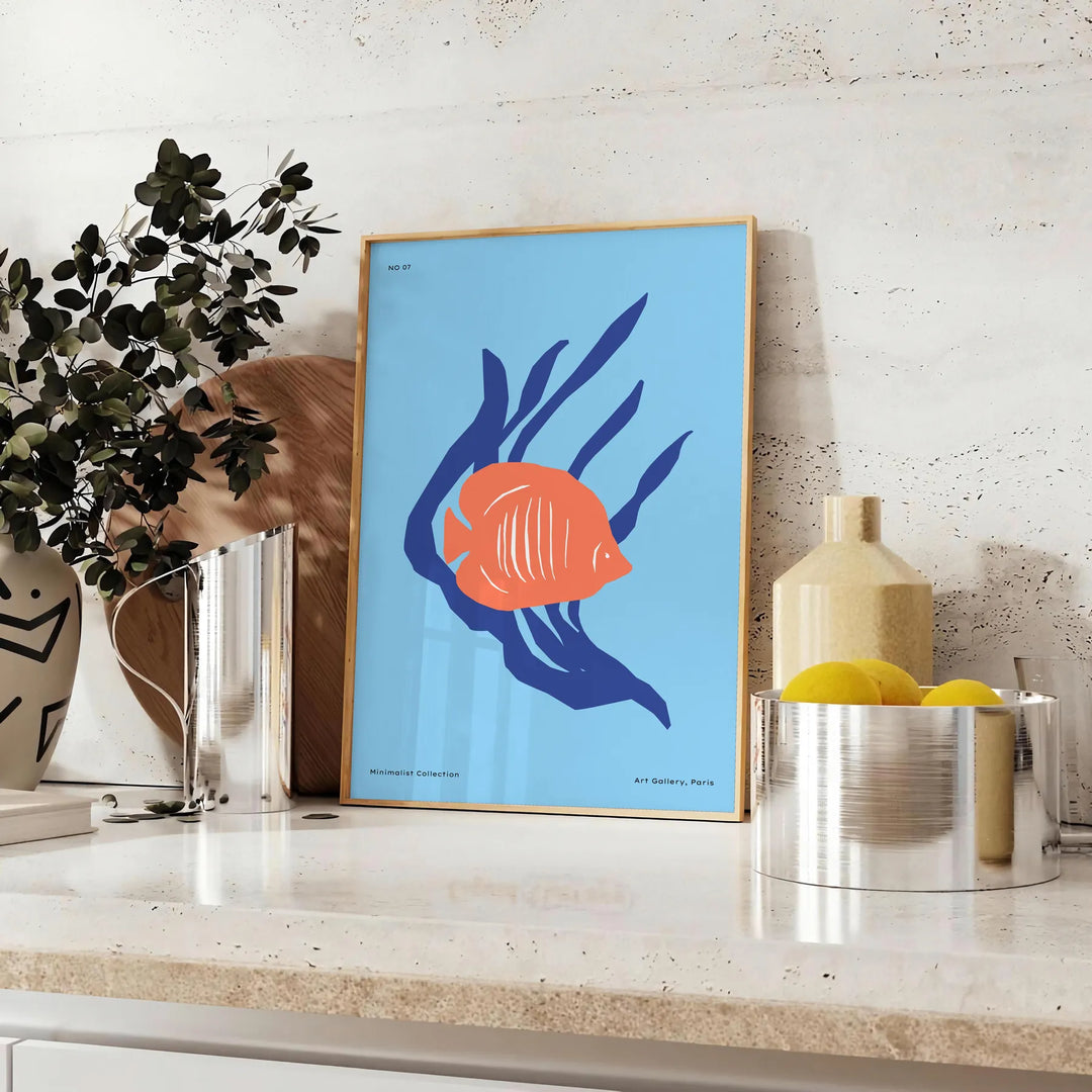 A colorful depiction of ocean wildlife featuring orange and blue hues - styled on a counter with eucalyptus and a bowl of lemons