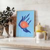 A colorful depiction of ocean wildlife featuring orange and blue hues - styled on a counter with eucalyptus and a bowl of lemons