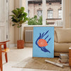 A colorful depiction of ocean wildlife featuring orange and blue hues - in a Parisian living room with a sofa and a fig plant