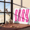 Motivational poster with the phrase 'Okay' in pink and white colors - leaning on a herringbone floor against a white panelled wall