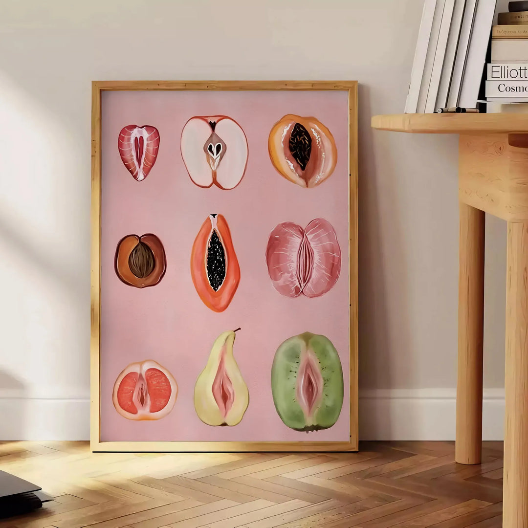 Graphic print of assorted fruits in bold black and brown tones - beside a round wooden side table with books