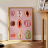 Graphic print of assorted fruits in bold black and brown tones - beside a round wooden side table with books