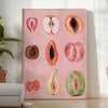 Graphic print of assorted fruits in bold black and brown tones - in a bright minimalist room with a plant and an armchair