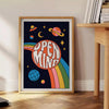 Abstract design featuring swirling orange and black shapes with a retro vibe - beside a round wooden side table with books