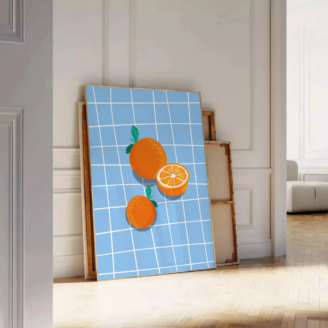 A bold orange kitchen poster featuring cooking utensils and ingredients in a modern style - leaning on a herringbone floor against a white panelled wall