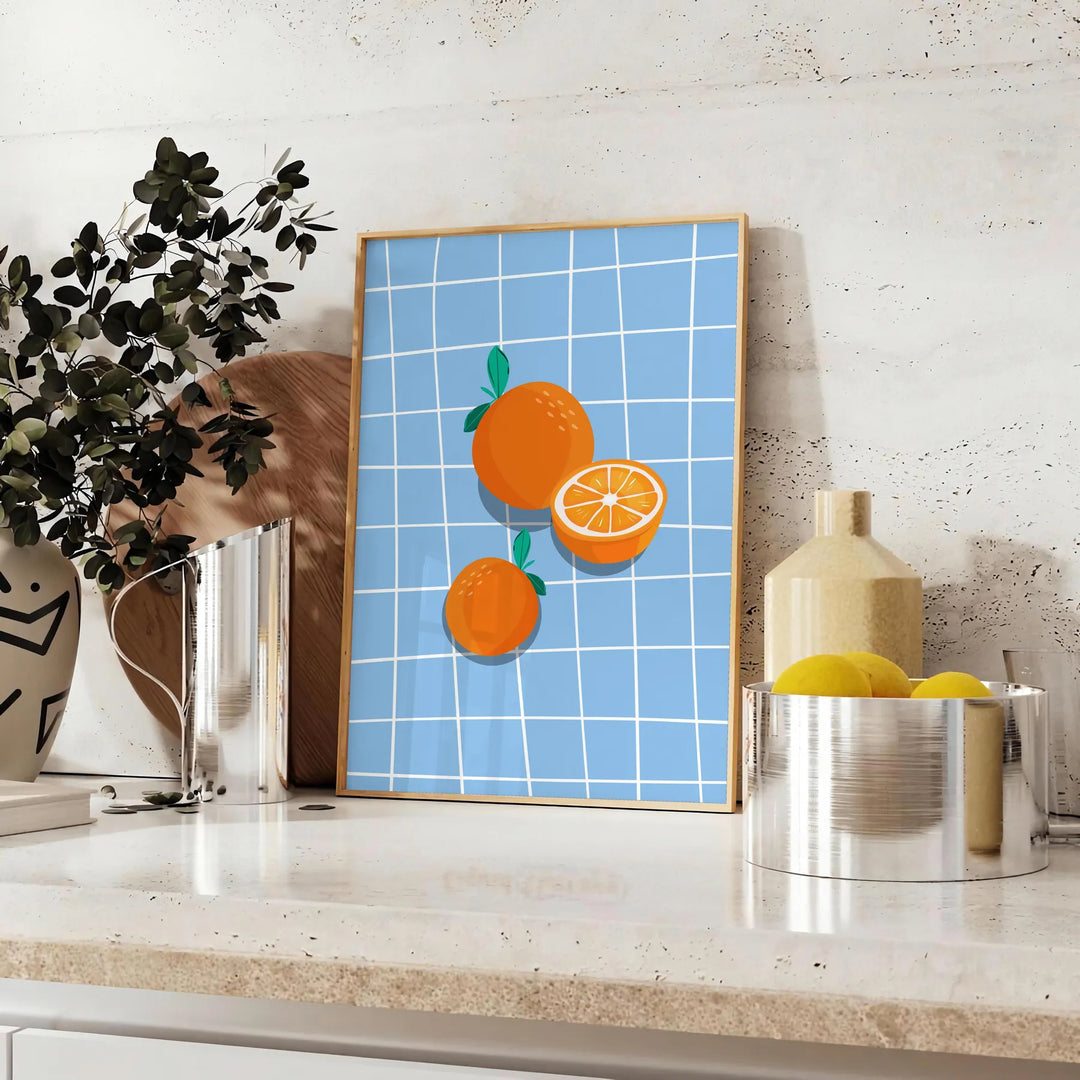 A bold orange kitchen poster featuring cooking utensils and ingredients in a modern style - styled on a counter with eucalyptus and a bowl of lemons
