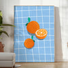 A bold orange kitchen poster featuring cooking utensils and ingredients in a modern style - in a bright minimalist room with a plant and an armchair
