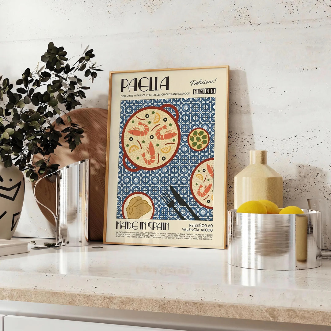 A colorful illustration of paella in a kitchen setting with blue and green tones - styled on a counter with eucalyptus and a bowl of lemons