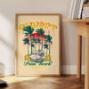 Vintage travel poster of Palm Beach, Miami with retro design and blue-orange colors - beside a round wooden side table with books