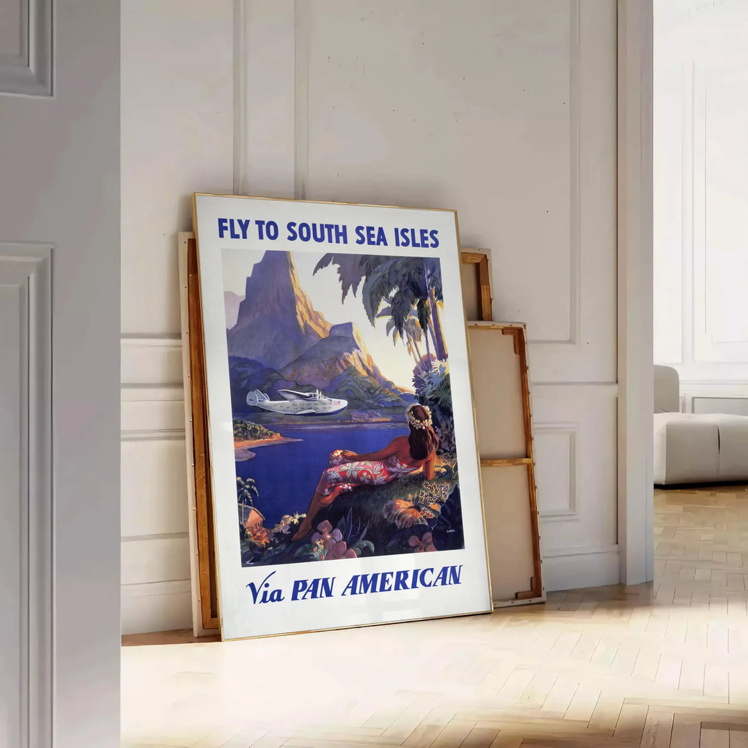 Vintage Pan American travel poster featuring a stylized airplane against a blue background - leaning on a herringbone floor against a white panelled wall