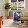 Vintage Pan American travel poster featuring a stylized airplane against a blue background - in a Parisian living room with a sofa and a fig plant