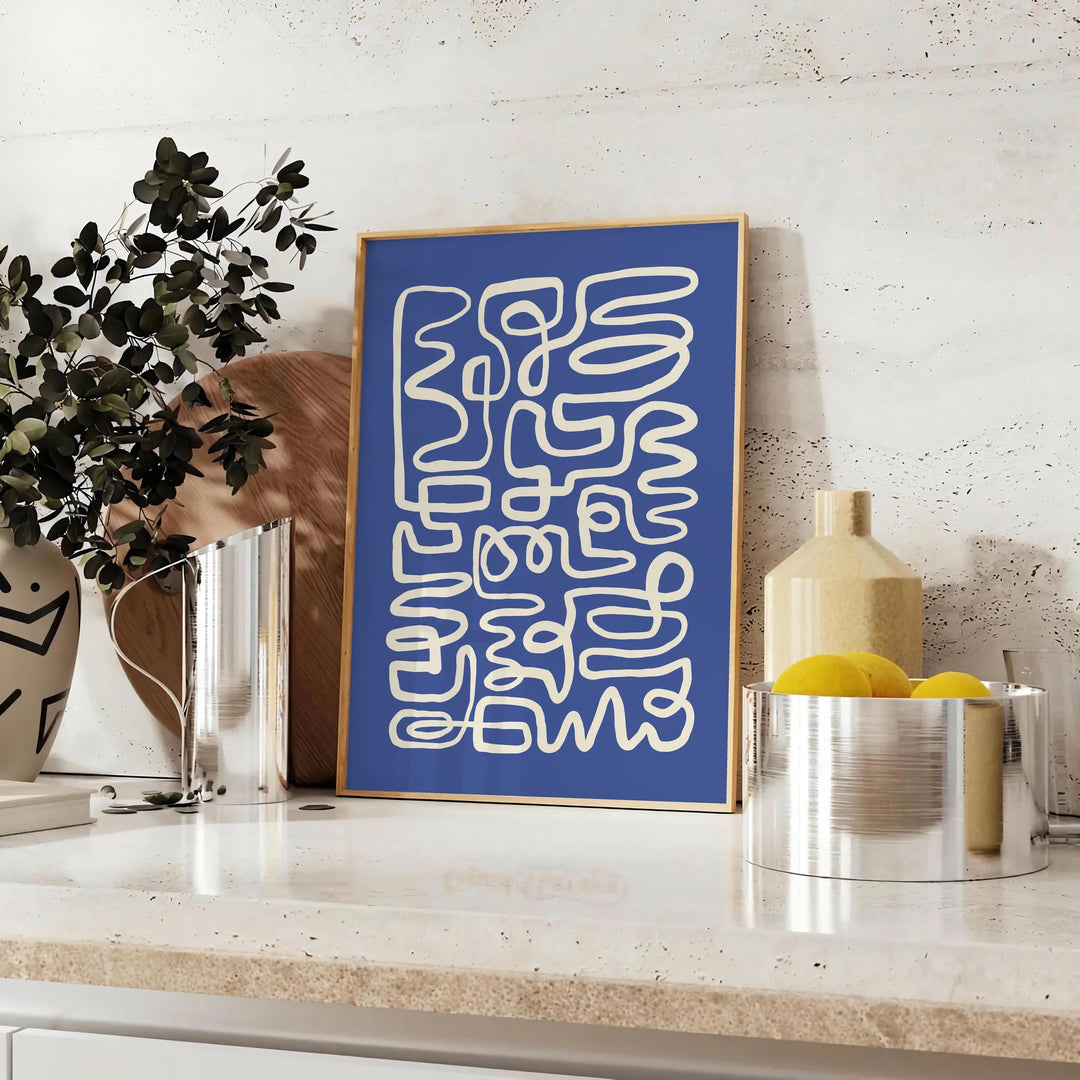 Abstract gray and white paper-cut design with minimalist shapes - styled on a counter with eucalyptus and a bowl of lemons