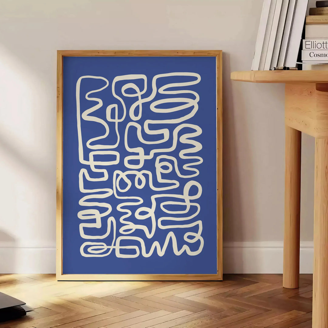 Abstract gray and white paper-cut design with minimalist shapes - beside a round wooden side table with books
