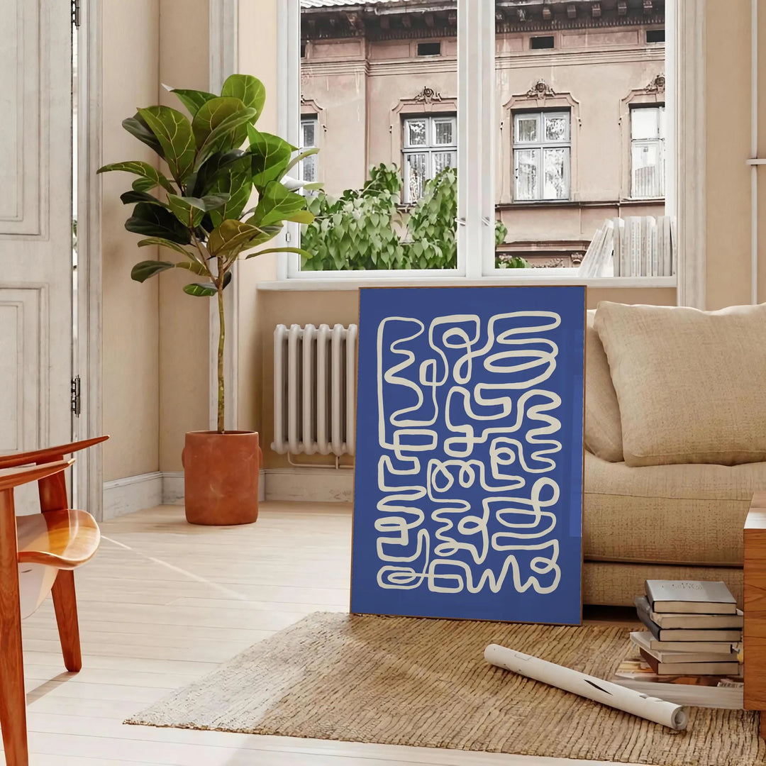 Abstract gray and white paper-cut design with minimalist shapes - in a Parisian living room with a sofa and a fig plant