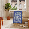 Abstract gray and white paper-cut design with minimalist shapes - in a Parisian living room with a sofa and a fig plant