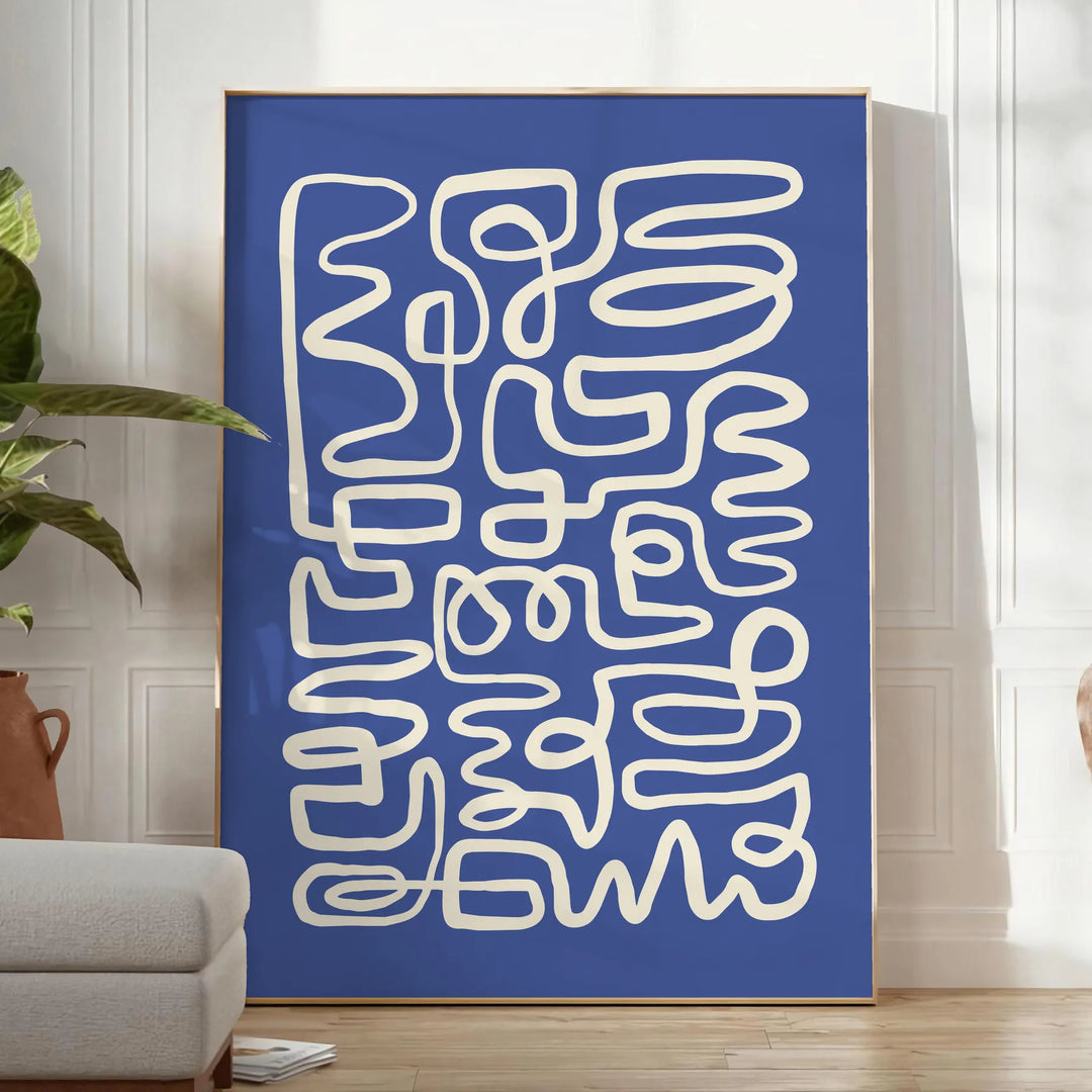 Abstract gray and white paper-cut design with minimalist shapes - in a bright minimalist room with a plant and an armchair