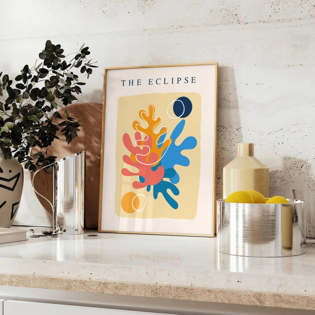 Layered paper cut design featuring abstract shapes in orange and blue - styled on a counter with eucalyptus and a bowl of lemons