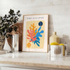 Layered paper cut design featuring abstract shapes in orange and blue - styled on a counter with eucalyptus and a bowl of lemons