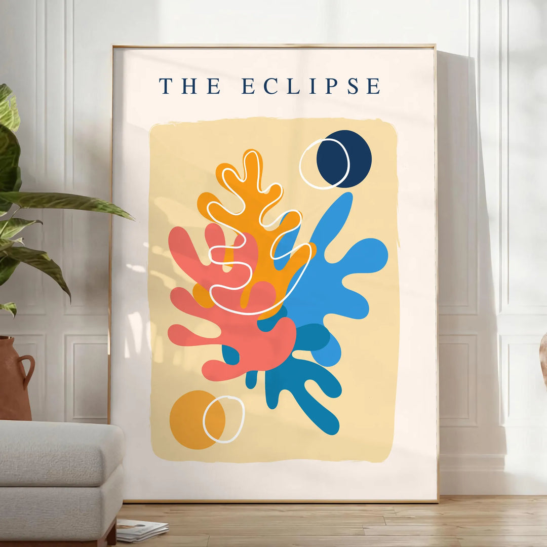 Layered paper cut design featuring abstract shapes in orange and blue - in a bright minimalist room with a plant and an armchair