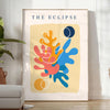 Layered paper cut design featuring abstract shapes in orange and blue - in a bright minimalist room with a plant and an armchair