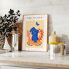 Papier découpé artwork featuring intricate cut-out designs in orange and blue - styled on a counter with eucalyptus and a bowl of lemons