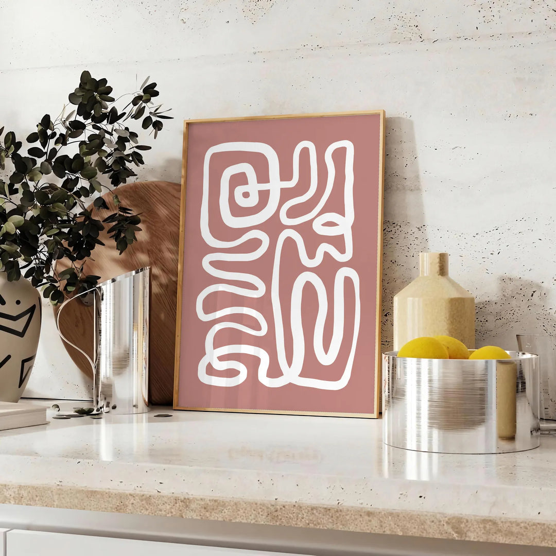 Minimalist paper-cut artwork in white and brown, layered abstract design - styled on a counter with eucalyptus and a bowl of lemons