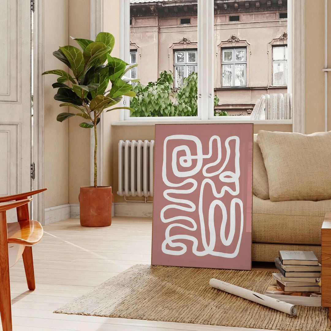 Minimalist paper-cut artwork in white and brown, layered abstract design - in a Parisian living room with a sofa and a fig plant